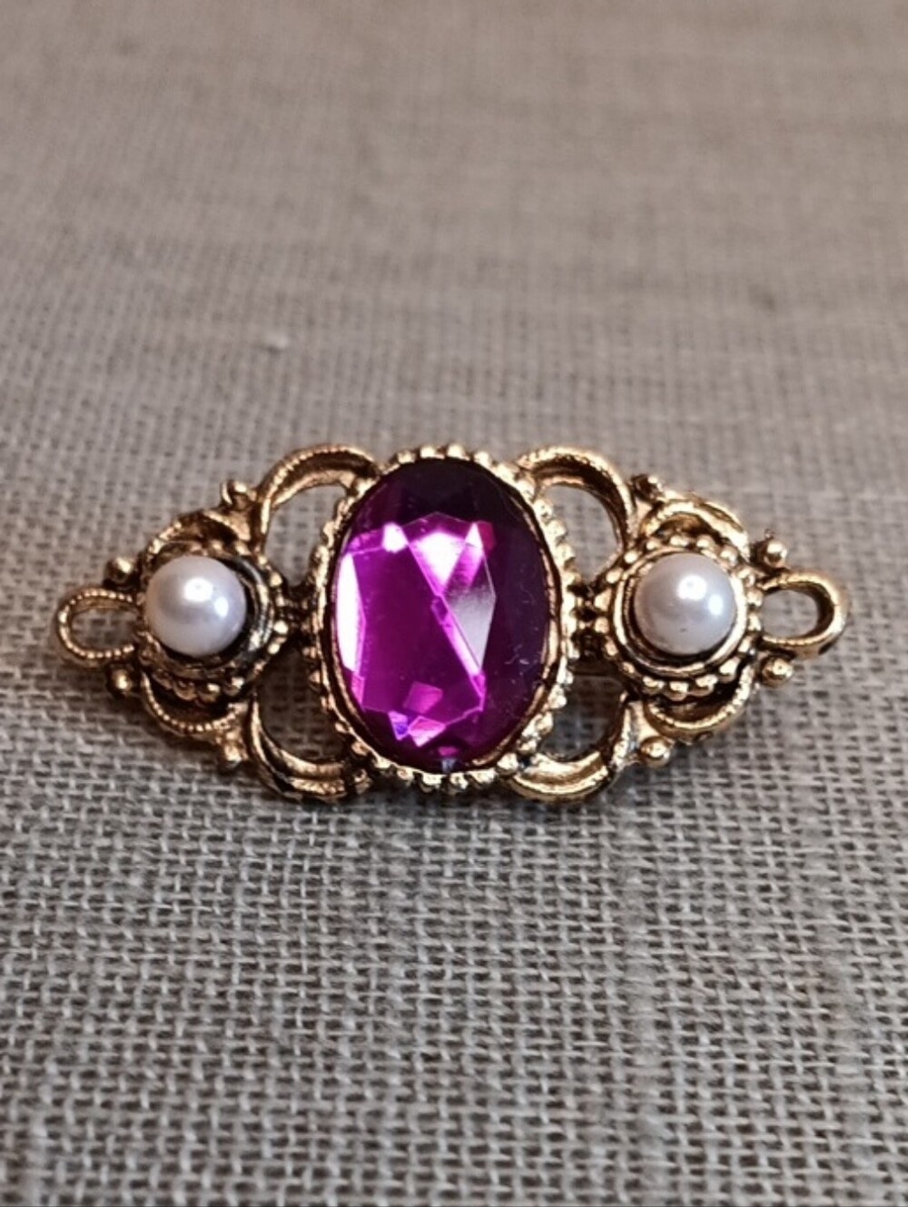 1928 Gold-Tone Brooch with Purple Stone and Pearl Accents